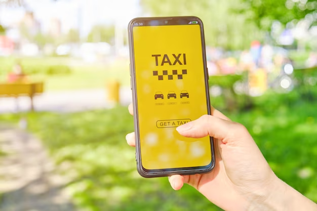 Hand holding a phone with a taxi app on the screen